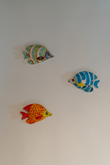 Colorful ceramic fish on wall